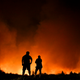 Residents watch as a wildfire sweeps through Portezuelo, Chile, on Jan. 29, 2017. Image: AP Photo/Esteban Felix